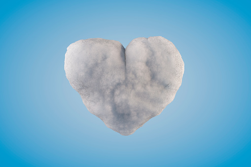 Heart shape with snow on blue background. Digitally generated image.