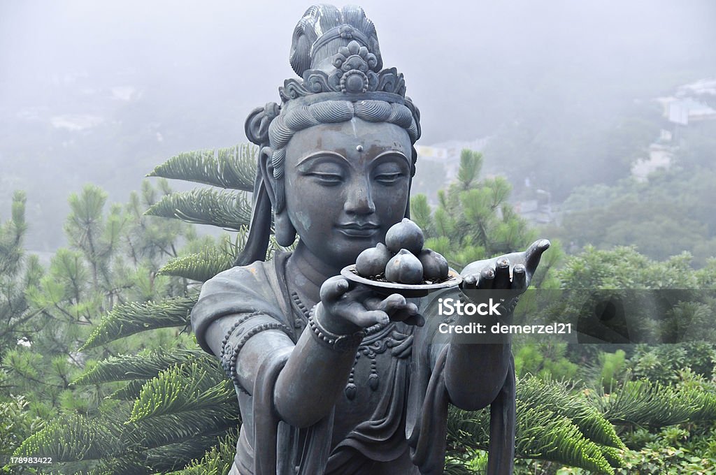 Statue of Tian Tan Buddha Complex Statue neighboring Tian Tan Buddha shrouded in fog. Asia Stock Photo