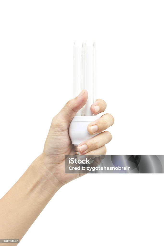 Hand holdind energy saving fluorescent lamp isolated on white ba Hand holdind energy saving fluorescent lamp isolated on white background. Adult Stock Photo