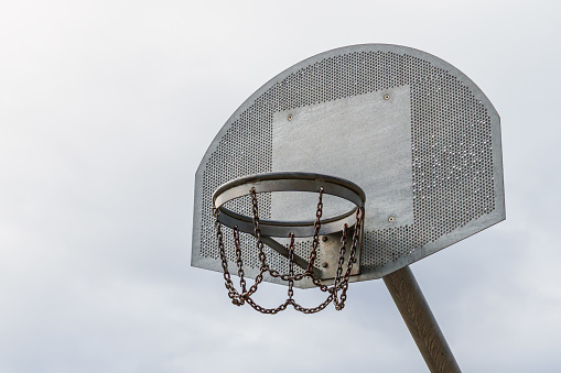 Outdoor basketball steel hoop with a metal chain close up