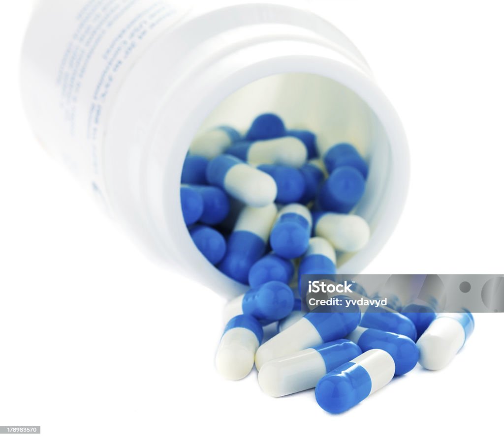 Closeup of pills isolated on white background. Blue Stock Photo