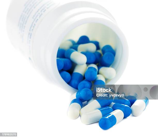 Closeup Of Pills Isolated On White Background Stock Photo - Download Image Now - Blue, Bottle, Capsule - Medicine
