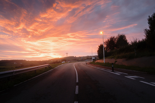 An empty road under a beautiful sunset sky