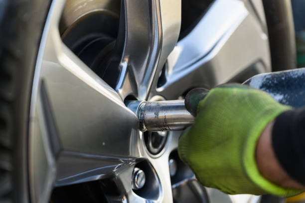 istock Car mechanic changing wheels in car 1789851733