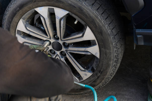 istock Car mechanic changing wheels in car 1789851749