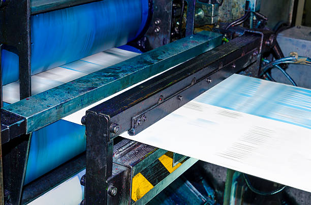 Web set Printing machine runs at high speed publishing newspaper Blurred view of printing machine, hith speed roto offset print press, newspaper and magazine production industry rolled up magazine stock pictures, royalty-free photos & images