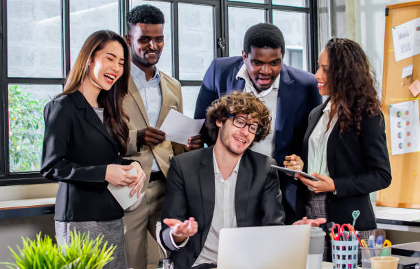 istock Diverse and multiracial smart businesspeople wearing formal suits, using computer, discussing by teleconference, brainstorming idea for company marketing plan in indoor modern office. 1789853847