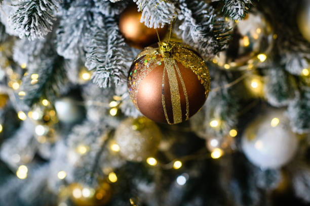 istock Christmas tree bulbs with yellow garlands, xmas tree with decorative bulbs. 1789858063