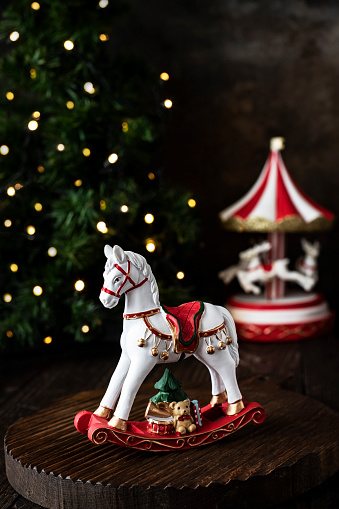 Christmas concept background.  Christmas composition  with horse toy on festive background