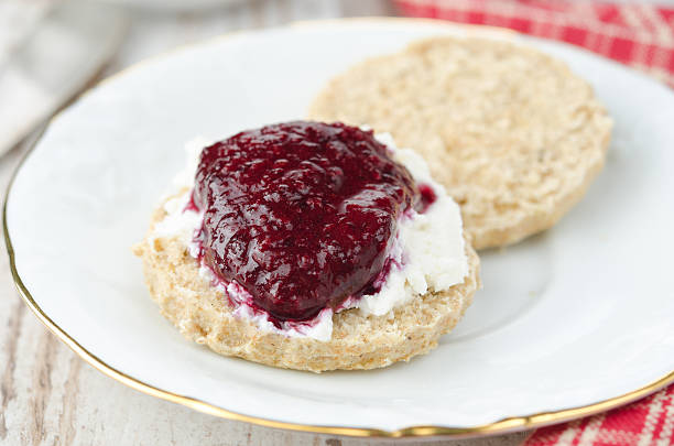 istock Scone with goat cheese and jam on a plate closeup 178987290