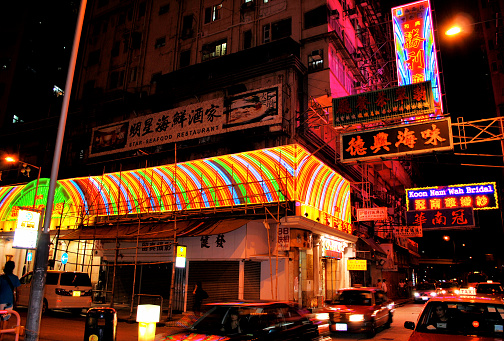 Hong Kong, or formally known as the Hong Kong Special Administrative Region of the People's Republic of China, is one of the most densely populated places in the world. This particular photograph shows a small segment of Hong Kong during nighttime, along with some of its many residents and perhaps a few tourists moving about. The photograph was snapped during September of 2010.