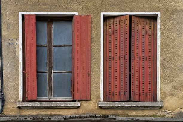 istock two windows with opened and closed red shutters and dirty window panes 1789885327