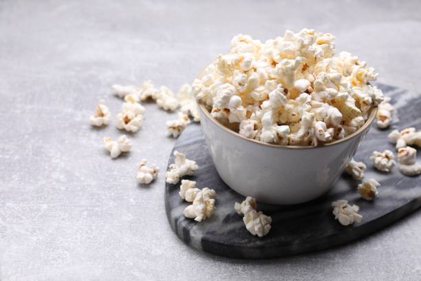 istock Bowl of tasty popcorn on grey table, space for text 1789887932