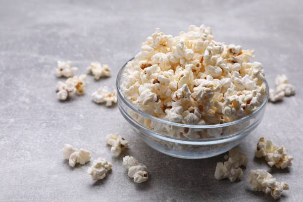 istock Bowl of tasty popcorn on grey table, space for text 1789888041