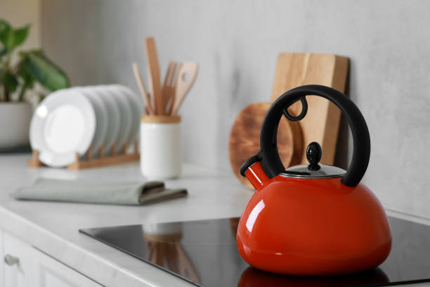 istock Red kettle with whistle on cooktop in kitchen. Space for text 1789888045