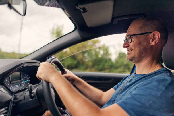 istock Happy man driving a car on a road trip 1789889642