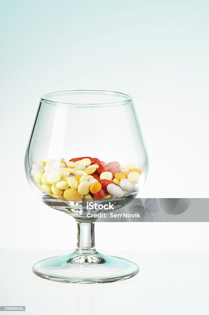 Glass full of pills Many drugs pills and tablets in the transparent glass Allegory Painting Stock Photo