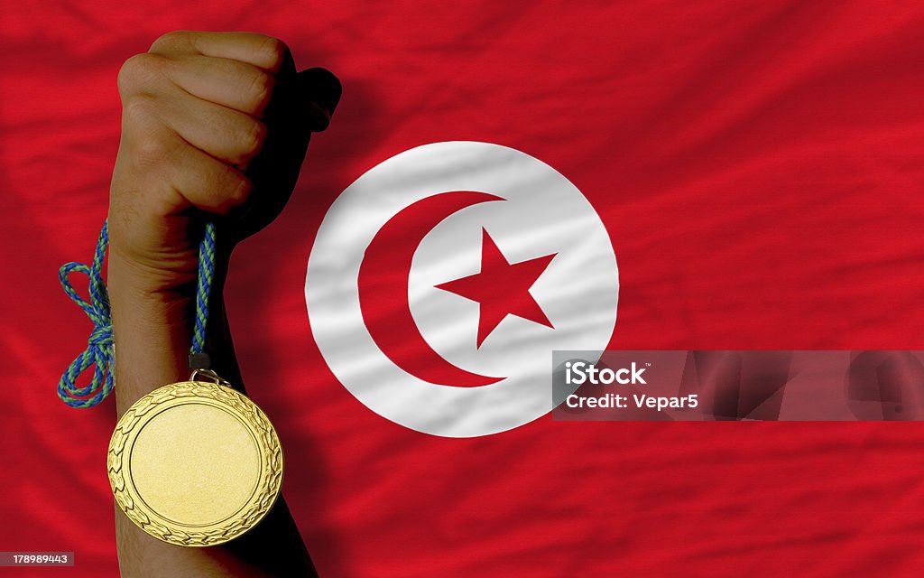 Medaglia d'oro per lo sport e la bandiera nazionale della tunisia - Foto stock royalty-free di Bandiera