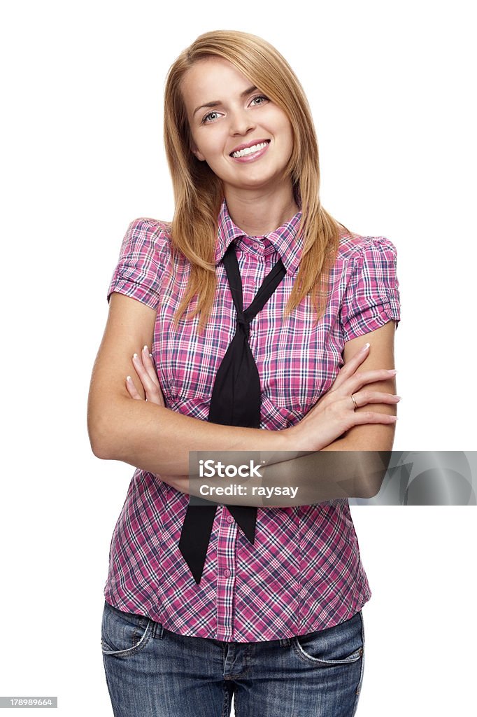 Young woman standing and smiling folded her hands Young woman standing and smiling folded her hands in studio Adult Stock Photo