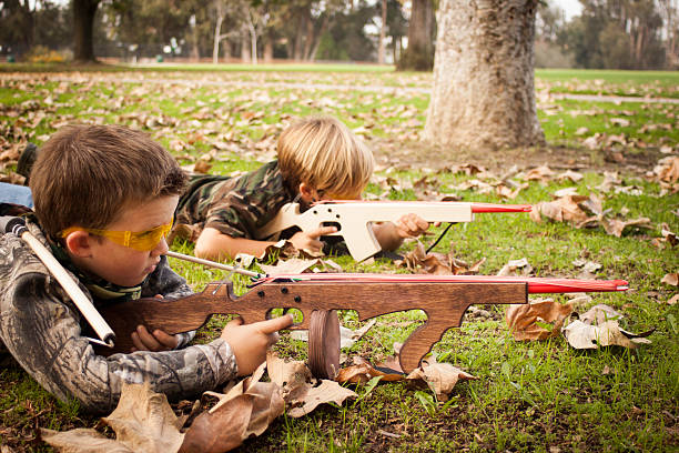 istock Boys playing with toy rubber band guns 178989833