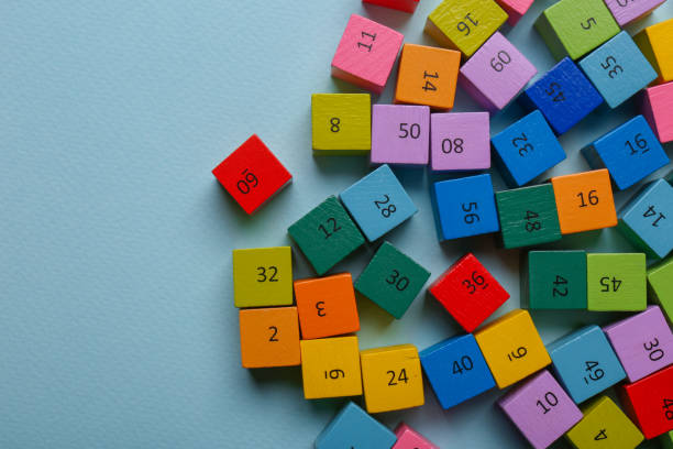 istock Wooden cubes with different numbers on light green background, flat lay. Space for text 1789899704