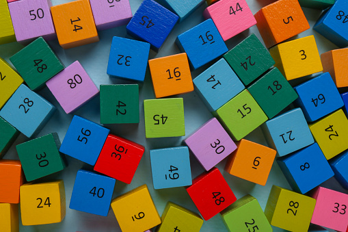 Wooden cubes with different numbers on color background, flat lay