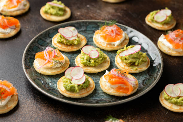 istock Mini blini pancakes with soft cheese, cold smoked salmon and guacamole 1789912335