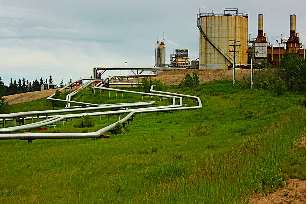 Oil Patch Oil pipes crawling up to the refinery. oilsands stock pictures, royalty-free photos & images