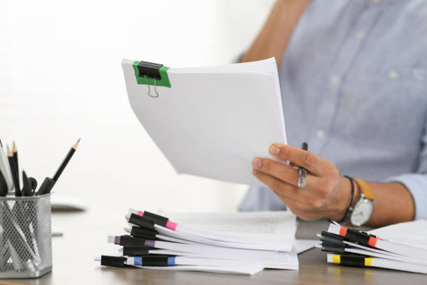 istock Man working with documents at wooden table in office, closeup 1789914402