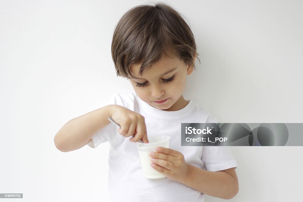 Menino comendo iogurte - Foto de stock de Iogurte royalty-free