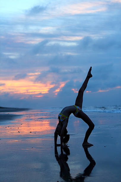 istock Young girl on beach at sunrise 178992645