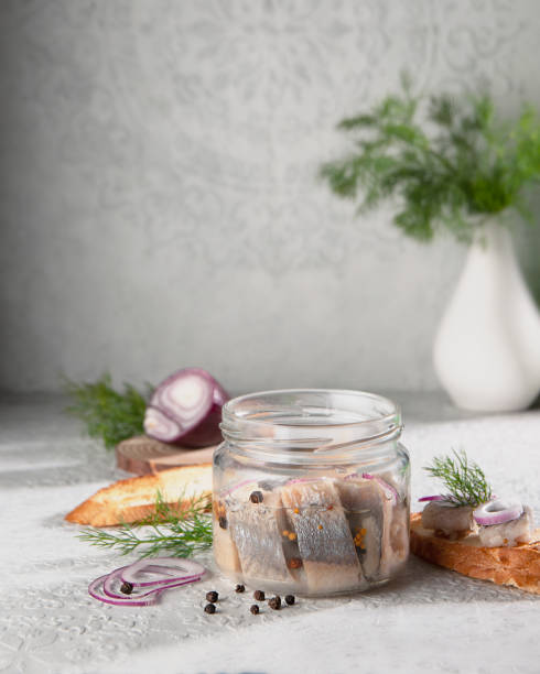 Herring lying in a jar with butter, onion and
pepper.