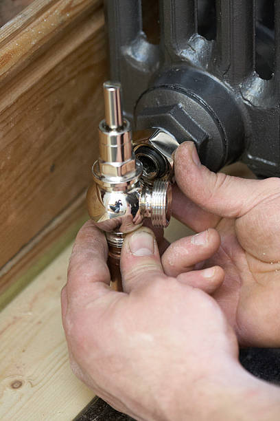 istock Plumber Fitting A New Radiator In House 178993094