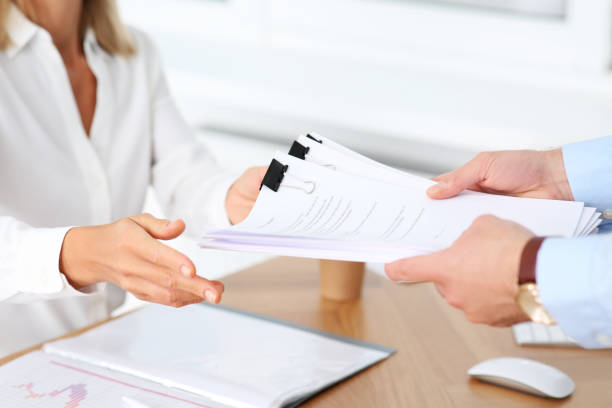 istock Man giving documents to colleague in office, closeup 1789932914