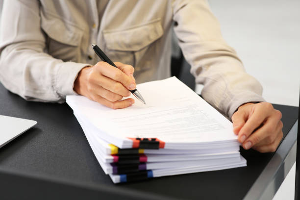 istock Businesswoman working with documents at dark table in office, closeup 1789933473