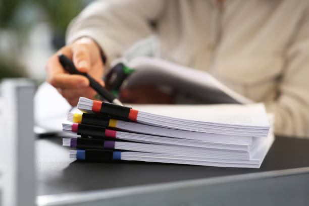 istock Businesswoman working with documents at grey table in office, closeup 1789934564