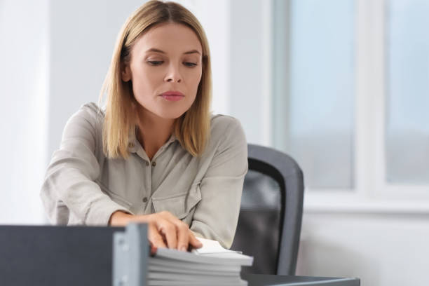 istock Businesswoman working with documents at table in office 1789935618