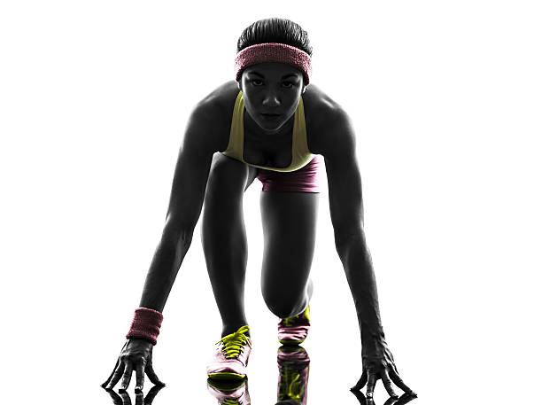 istock woman runner running on starting blocks silhouette 178993600