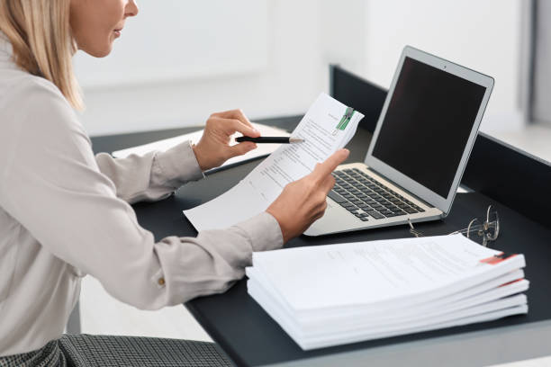 istock Businesswoman working with documents at grey table in office, closeup 1789937193