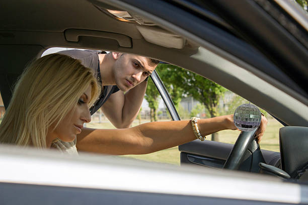 istock Guy looking inside the car where girl is sitting 178994218