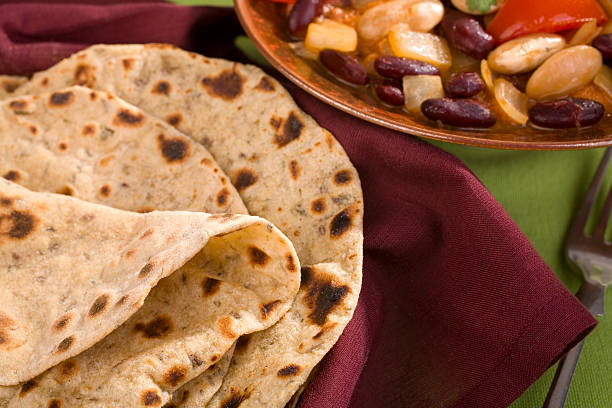 Close up detail shot of handmade Salvadoran Tortillas made on a hot fire heated skillet.