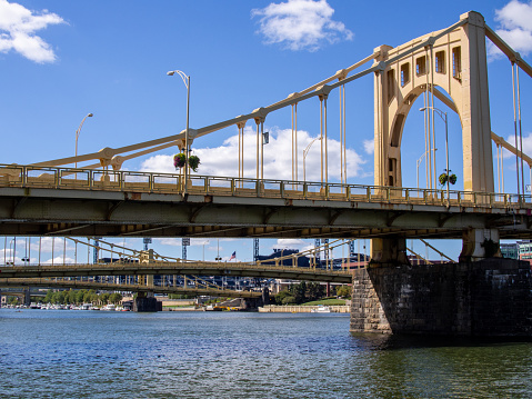 In the heart of Pittsburgh, Pennsylvania (PA), USA, the vibrant yellow bridges take center stage, reflecting the city's iconic charm. This image encapsulates the essence of Pittsburgh's urban character and distinctive architecture.