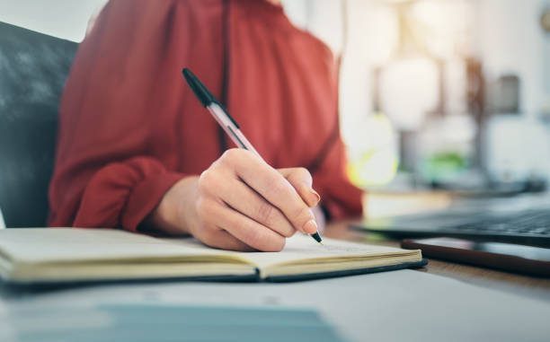 istock Hand, notebook and person writing, admin with schedule and brainstorming and planning work closeup in office. Business, ideas and notes with project deadline, productivity and workflow with research 1789958098