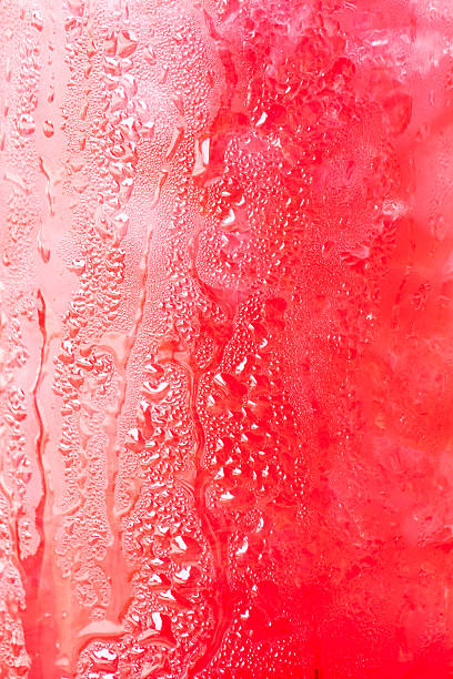 istock Glass surface of red drink with ice cubes background 178996038