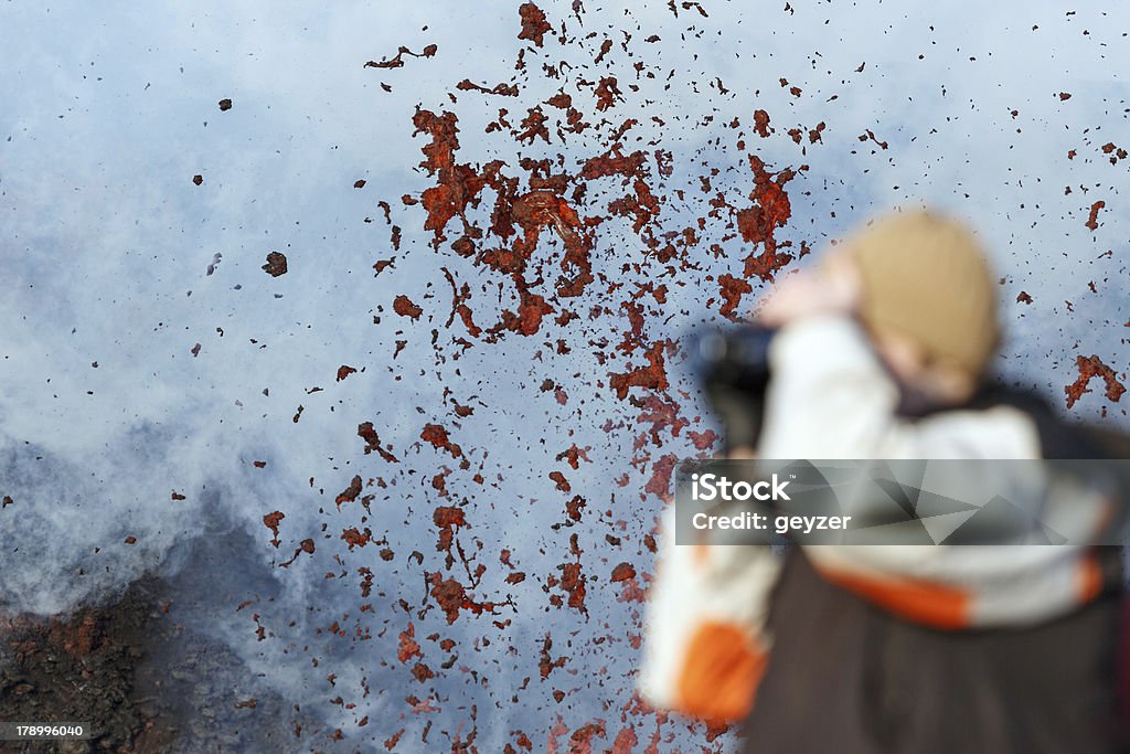 Photographer on the background of lava erupting volcano Eruption Tolbachic Volcano on Kamchatka Peninsula (Russia). Active Volcano Stock Photo