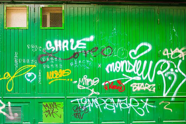 Photo of Graffiti on a green wooden wall