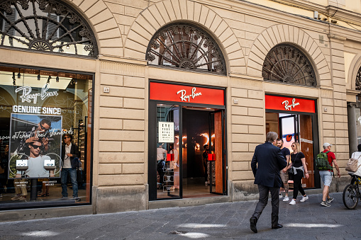 Florence, Italy - May 5, 2023: People walking past the Ray-Ban store at Via dei Calzaiuoli 44.