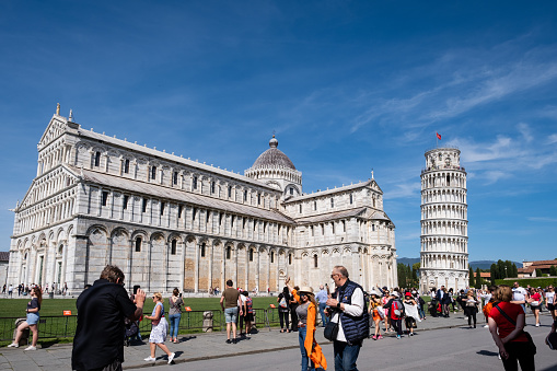 Pisa, Italy - May 5, 2023: The Tower of Pisa, the famous leaning freestanding bell tower of the Pisa Cathedral.