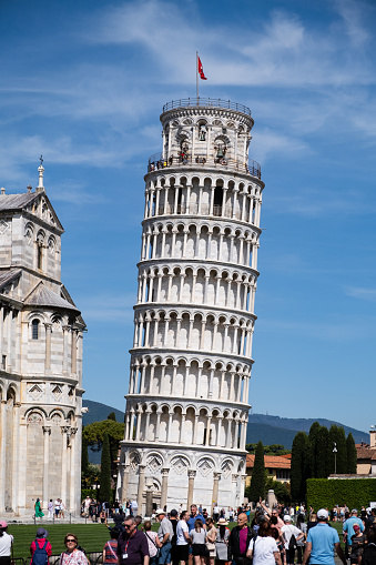 Pisa, Italy - May 5, 2023: The Tower of Pisa, the famous leaning freestanding bell tower of the Pisa Cathedral.