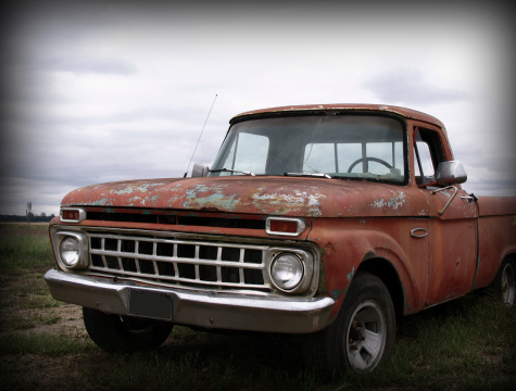 An old, deserted pickup truck on a dreary day